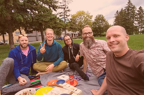 group of men and friends having a picnic in a park in Ottawa